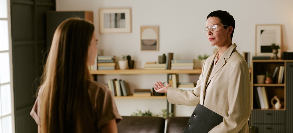 therapist speaking with client in office