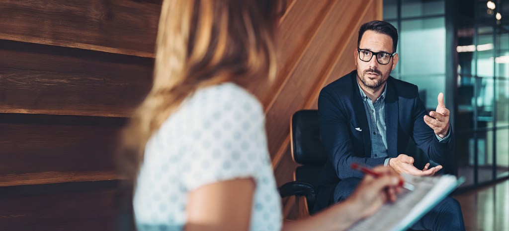 counselor and client discussing job loss